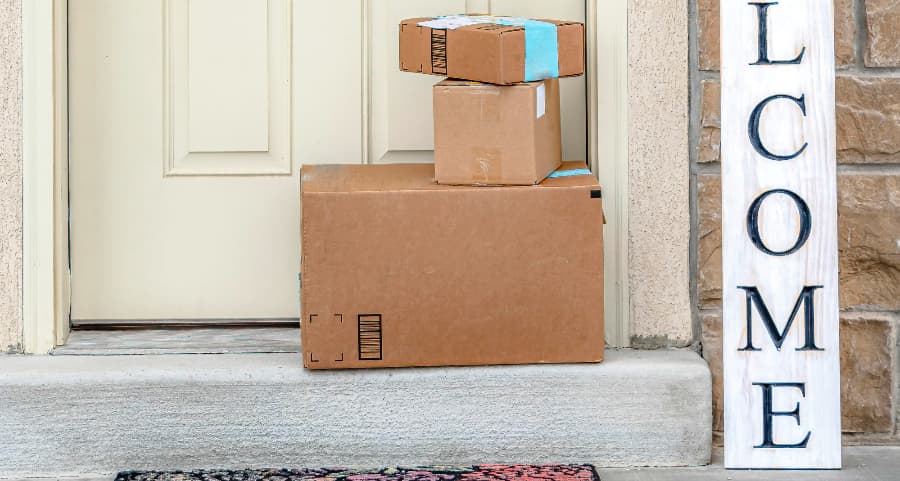 Packages on the doorstep of a home with a welcome sign in Peoria